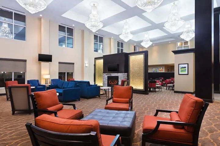Hotel lobby lounge with a warm fireplace feature wall finished by Yukon Wallpapers
