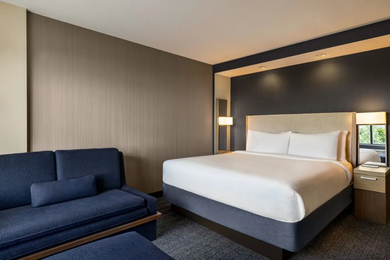Hotel guest room with a grasscloth accent wall installed by Yukon Wallpapers